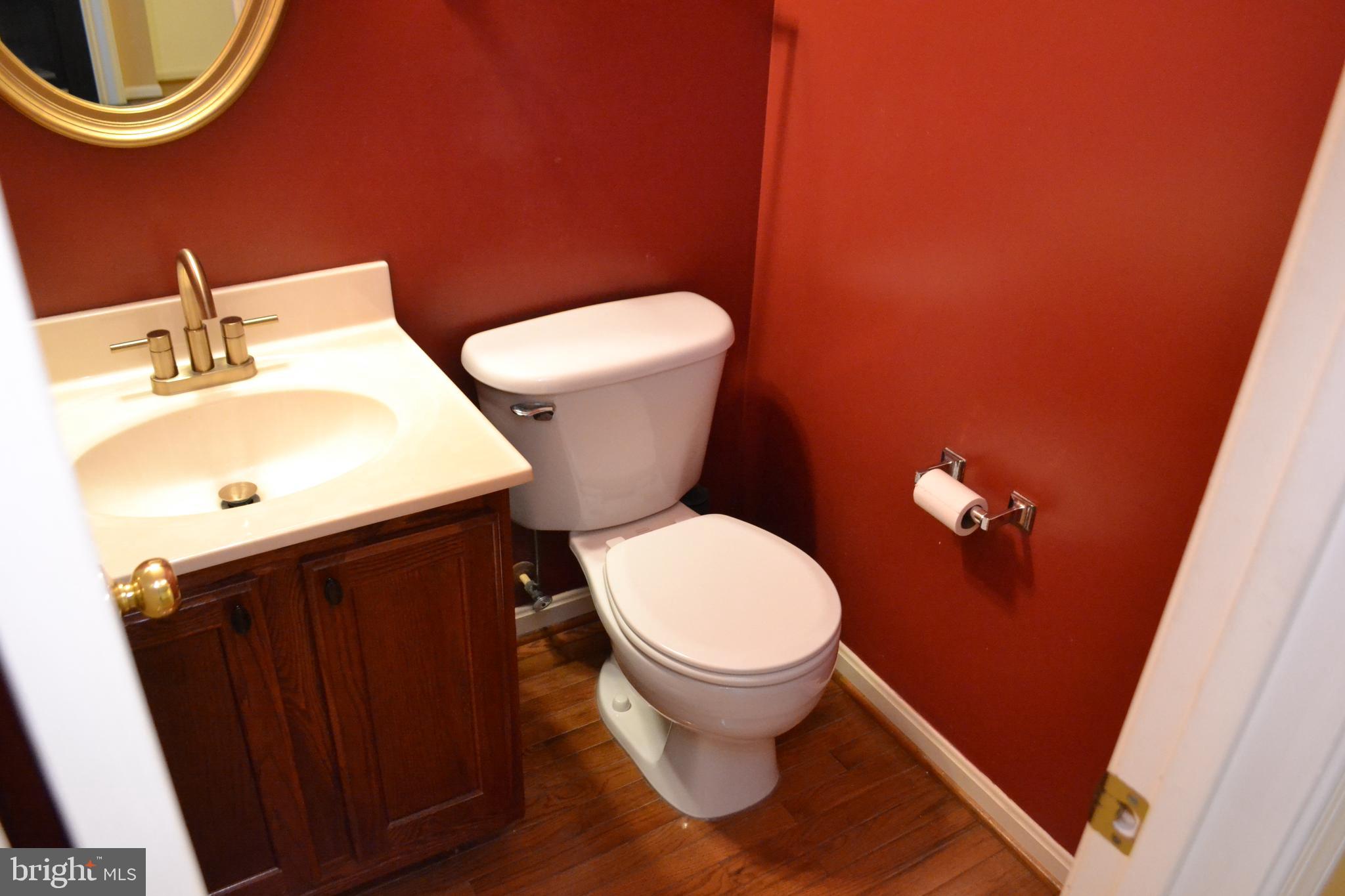 2202 Garden Lane Frederick, MD 21701 - Photo 3 of 50 a white toilet sitting next to a bathroom sink