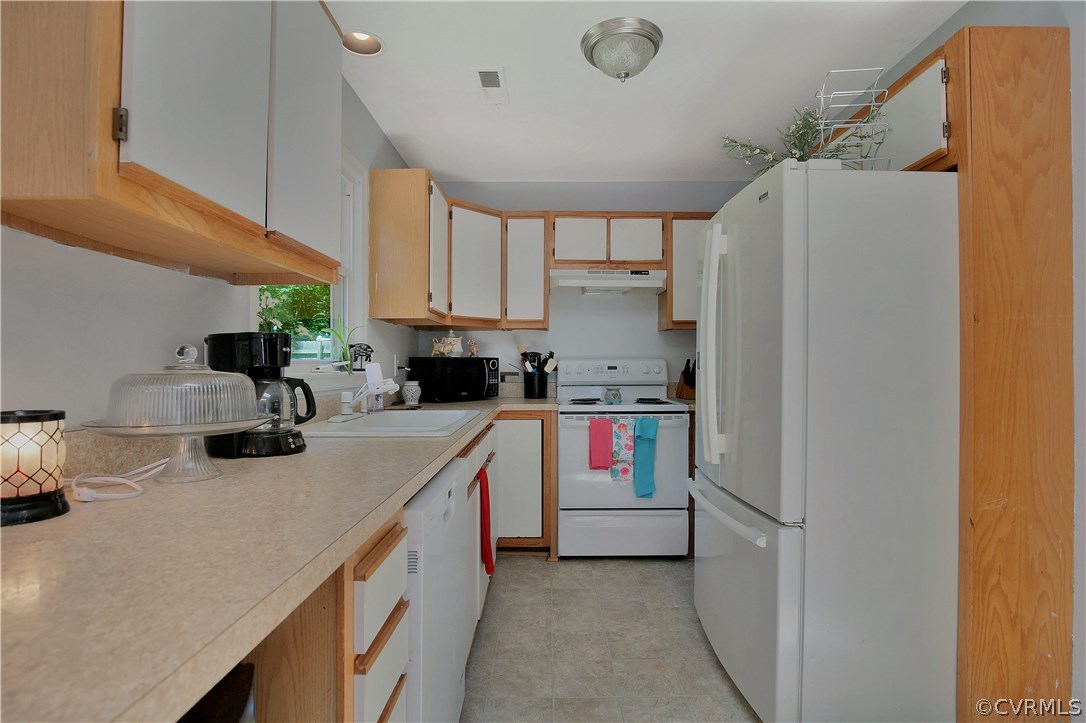 6702 Cherry Road Quinton, VA 23141 - Photo 11 of 20 a kitchen with a sink a refrigerator and cabinets
