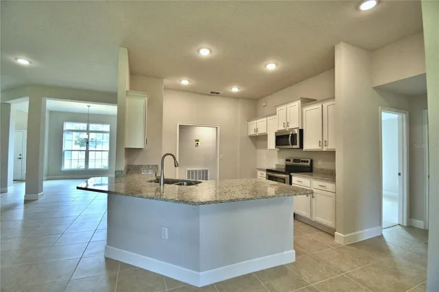 a kitchen with stainless steel appliances granite countertop a sink and cabinets
