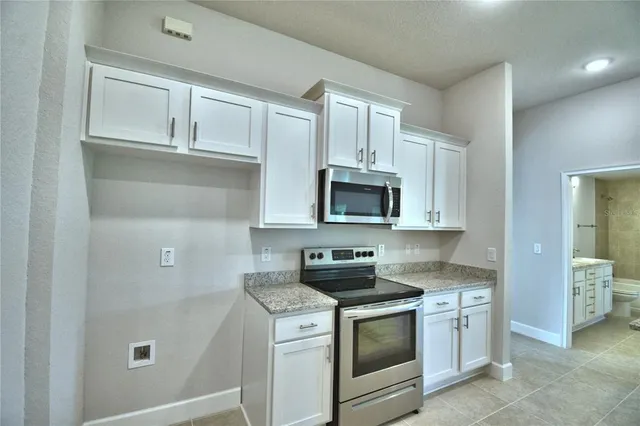 an empty room with closet and a bathroom