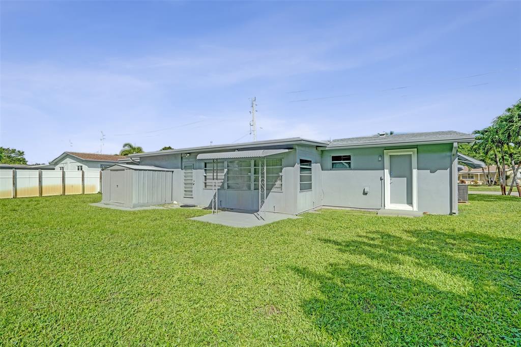 4738 Northwest 5th Street Plantation, FL 33317 - Photo 12 of 68 a view of a house with a yard and a garage