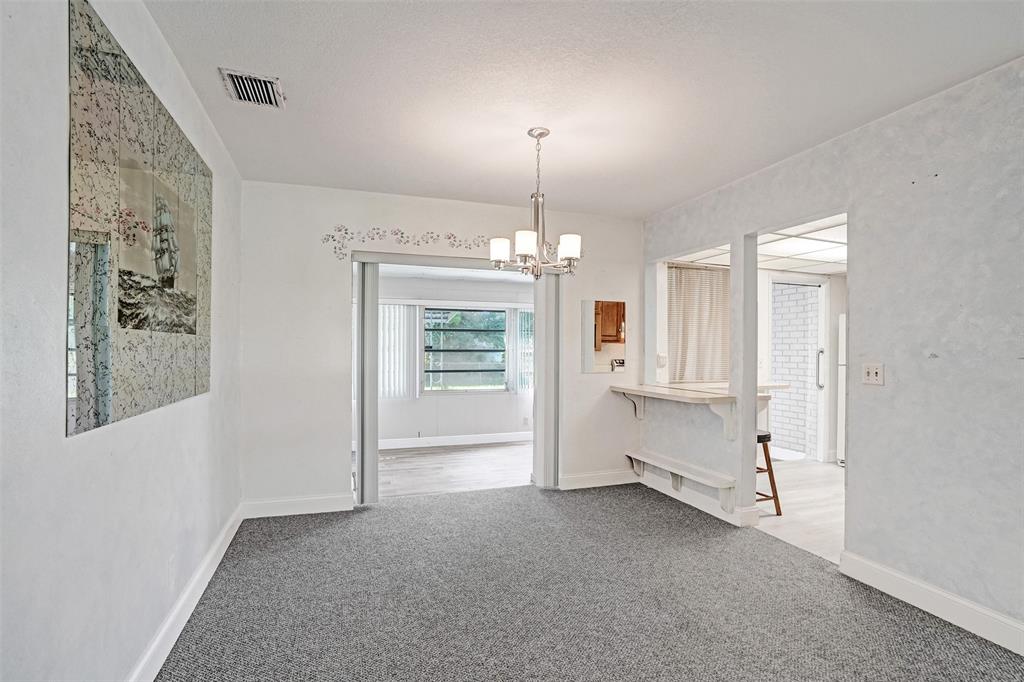 4738 Northwest 5th Street Plantation, FL 33317 - Photo 24 of 68 an empty room with chandelier fan and windows