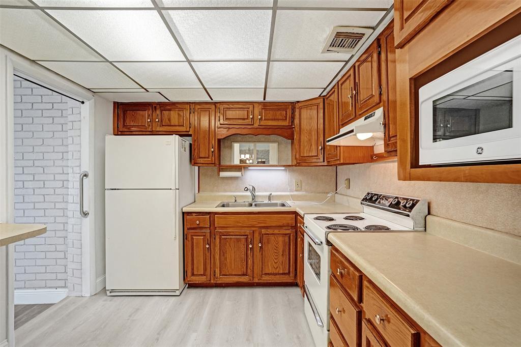 4738 Northwest 5th Street Plantation, FL 33317 - Photo 31 of 68 a kitchen with stainless steel appliances granite countertop a sink a stove a refrigerator a washer dryer and white cabinets