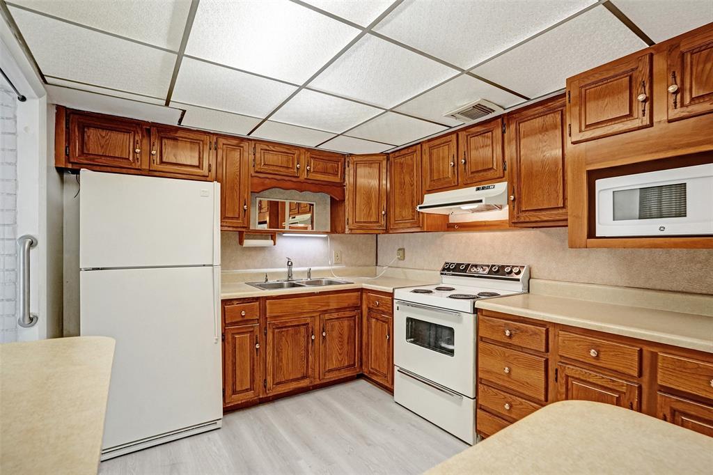 4738 Northwest 5th Street Plantation, FL 33317 - Photo 34 of 68 a kitchen with stainless steel appliances granite countertop a stove a refrigerator a sink dishwasher and white cabinets next to a window