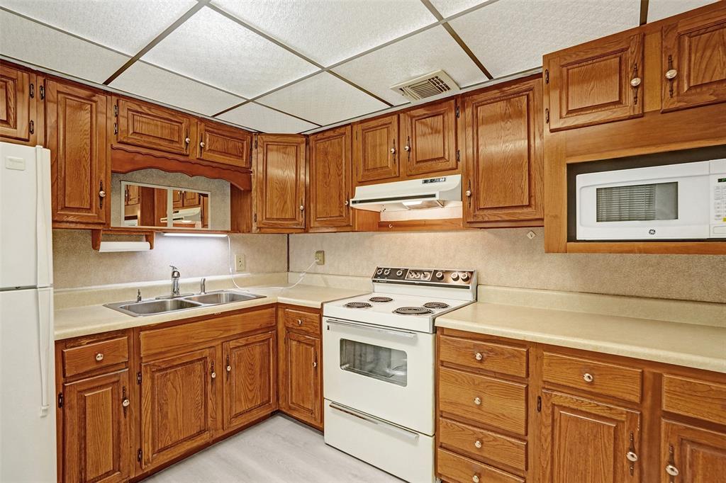 4738 Northwest 5th Street Plantation, FL 33317 - Photo 35 of 68 a kitchen with stainless steel appliances granite countertop a sink a stove and cabinets
