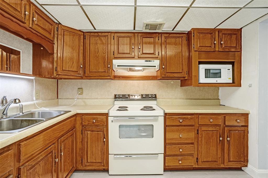 4738 Northwest 5th Street Plantation, FL 33317 - Photo 36 of 68 a kitchen with stainless steel appliances granite countertop a sink and cabinets