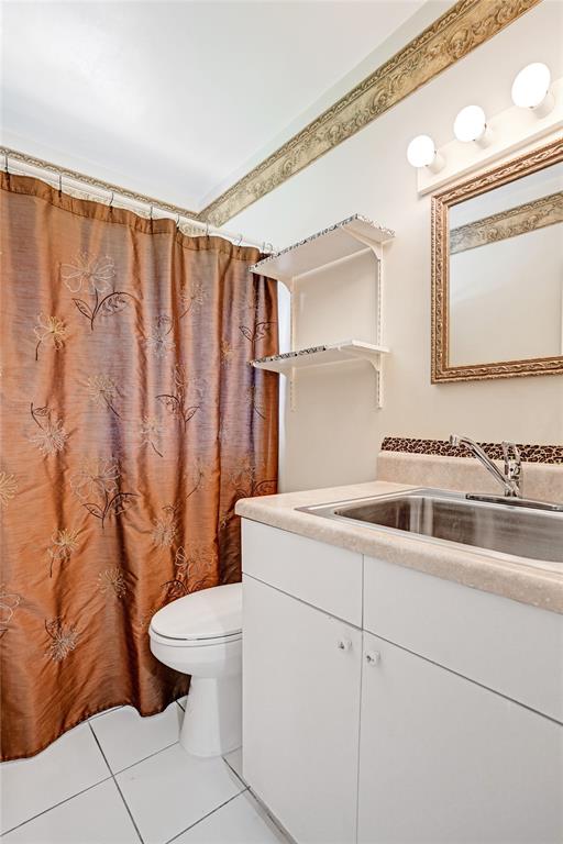 4738 Northwest 5th Street Plantation, FL 33317 - Photo 55 of 68 a bathroom with a sink a toilet and a mirror