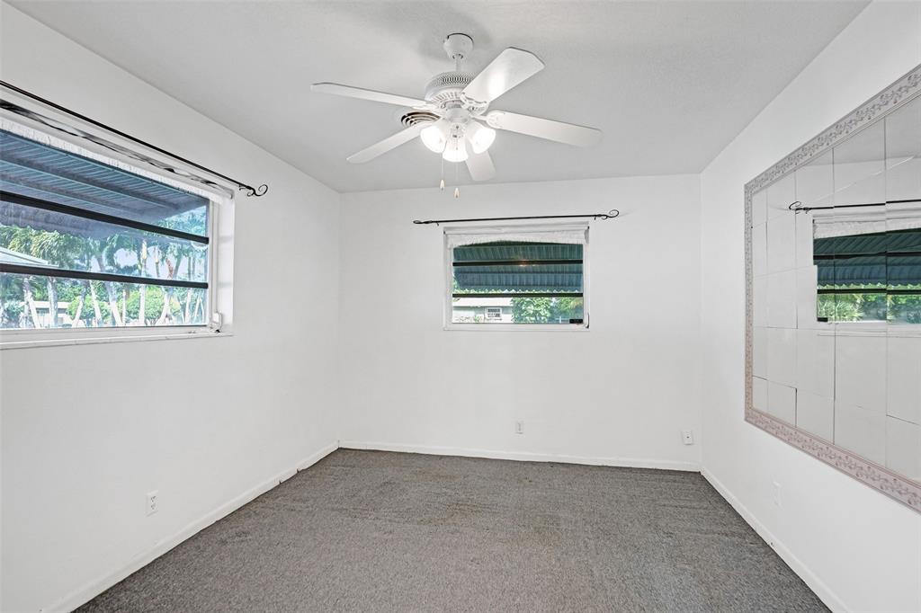 4738 Northwest 5th Street Plantation, FL 33317 - Photo 61 of 68 an empty room with a window and ceiling fan