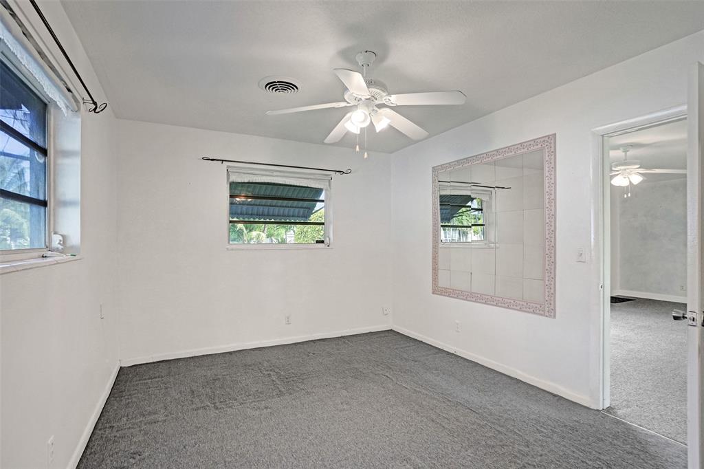 4738 Northwest 5th Street Plantation, FL 33317 - Photo 64 of 68 an empty room with windows and fan