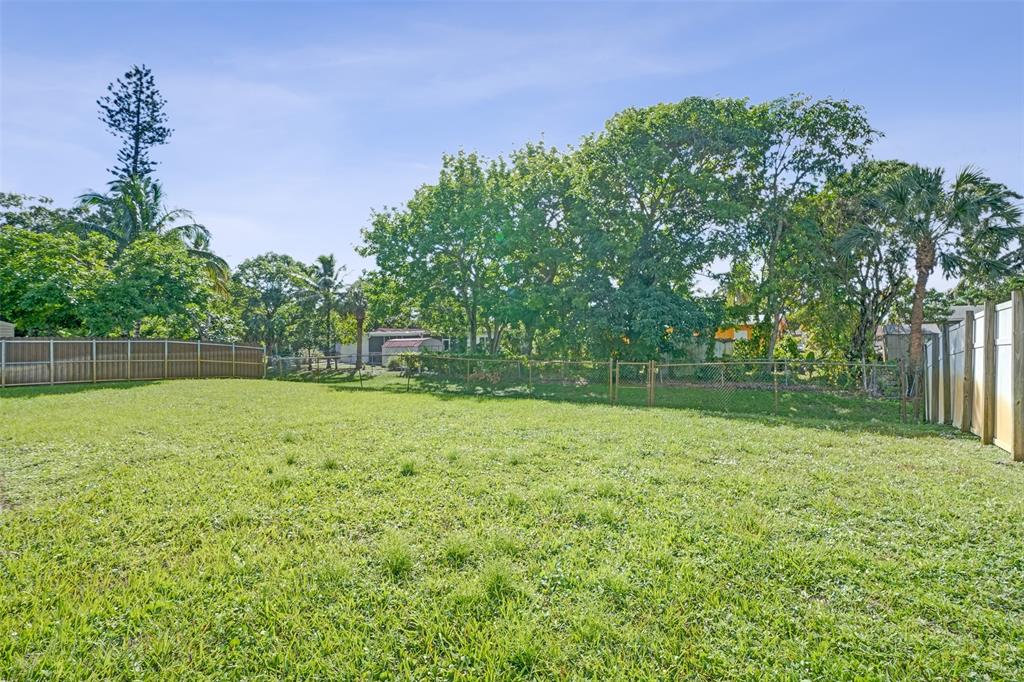 4738 Northwest 5th Street Plantation, FL 33317 - Photo 8 of 68 a backyard of a house with lots of green space