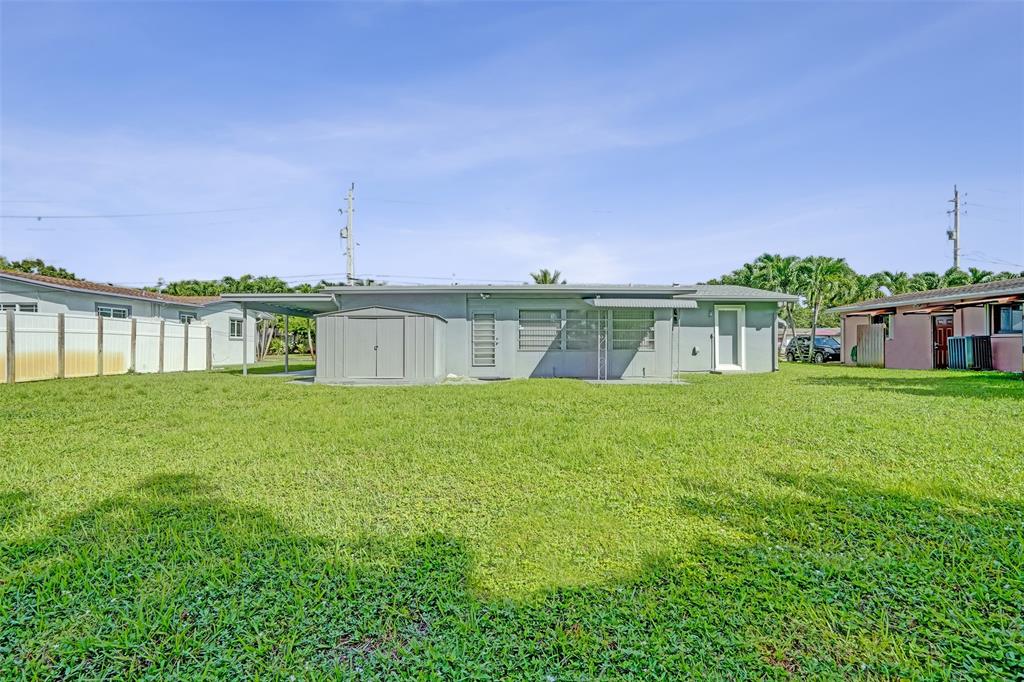 4738 Northwest 5th Street Plantation, FL 33317 - Photo 10 of 68 a front view of a house with a garden and yard
