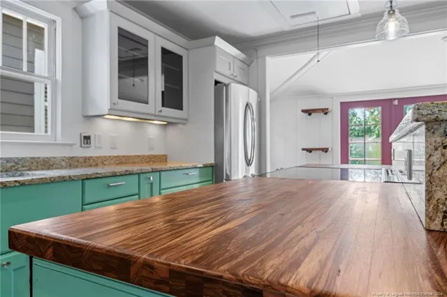 a large kitchen with a large window and stainless steel appliances