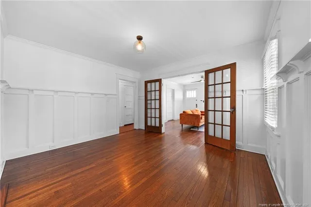 a view of a hallway with wooden floor and closet area