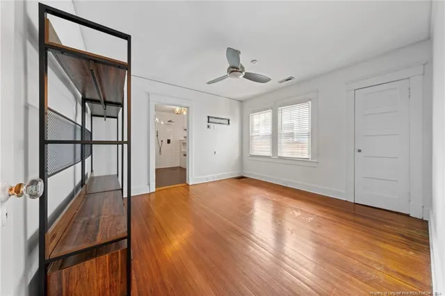 wooden floor in an empty room with a window