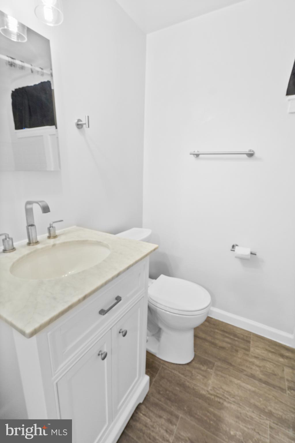 3572 Juneway, Unit 1 Baltimore, MD 21213 - Photo 13 of 23 a bathroom with a toilet sink and mirror