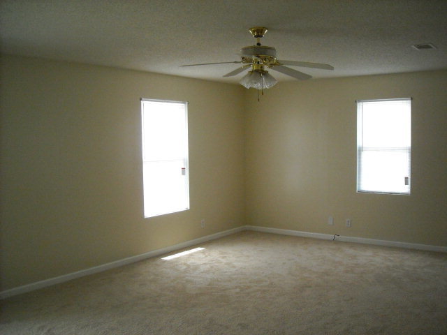 5899 Mt Pleasant Church Road Macon, GA 31216 - Photo 4 of 11 en empty room with windows and fan