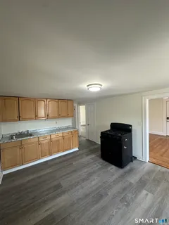 a living room with a couch and a wooden floor