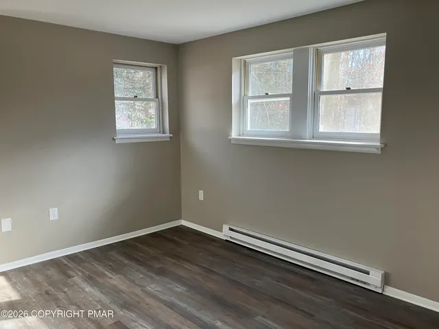 an empty room with wooden floor