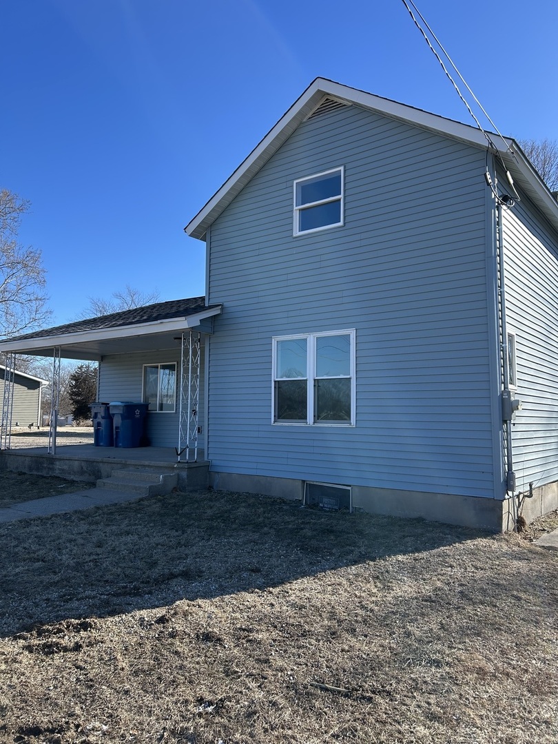 129 West Main Street Amboy, IL 61310 - Photo 11 of 40 a view of a house with a yard
