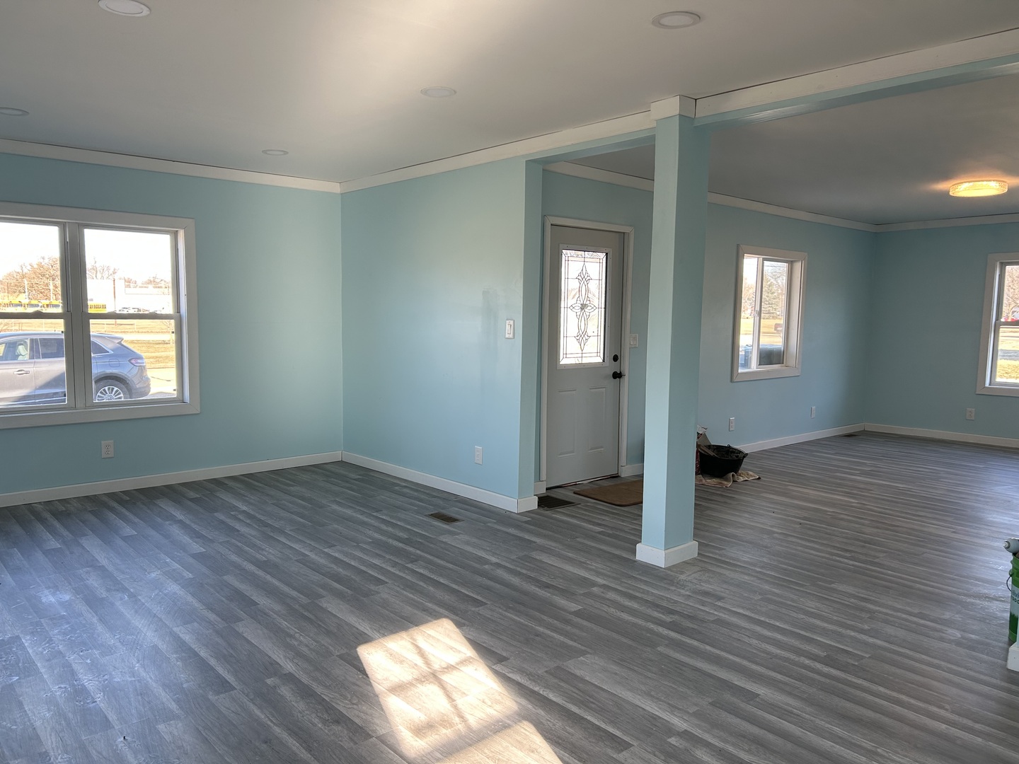 129 West Main Street Amboy, IL 61310 - Photo 12 of 40 an empty room with wooden floor and windows