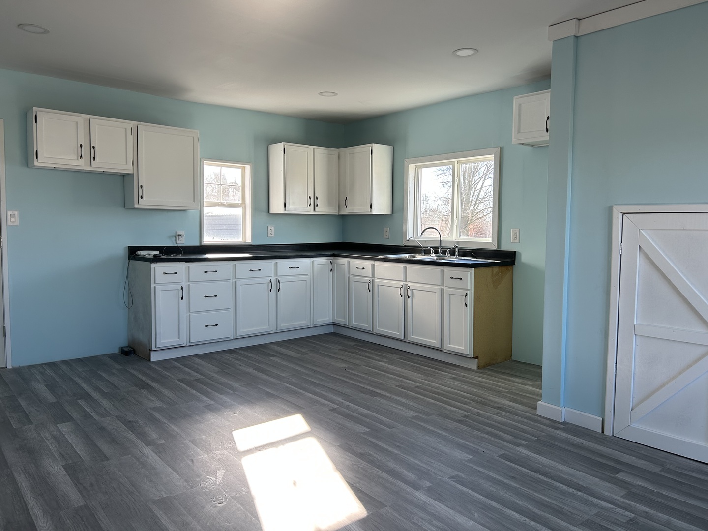129 West Main Street Amboy, IL 61310 - Photo 14 of 40 a kitchen with granite countertop a sink cabinets and wooden floor
