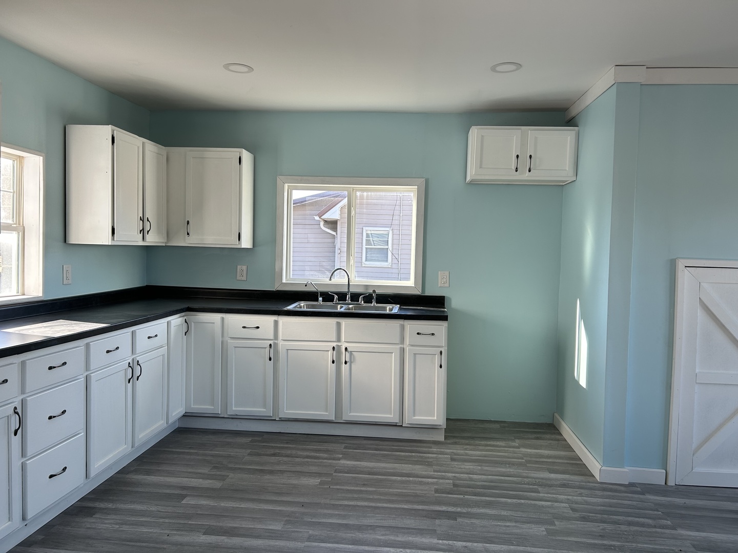 129 West Main Street Amboy, IL 61310 - Photo 15 of 40 a kitchen with granite countertop white cabinets white appliances and granite countertops