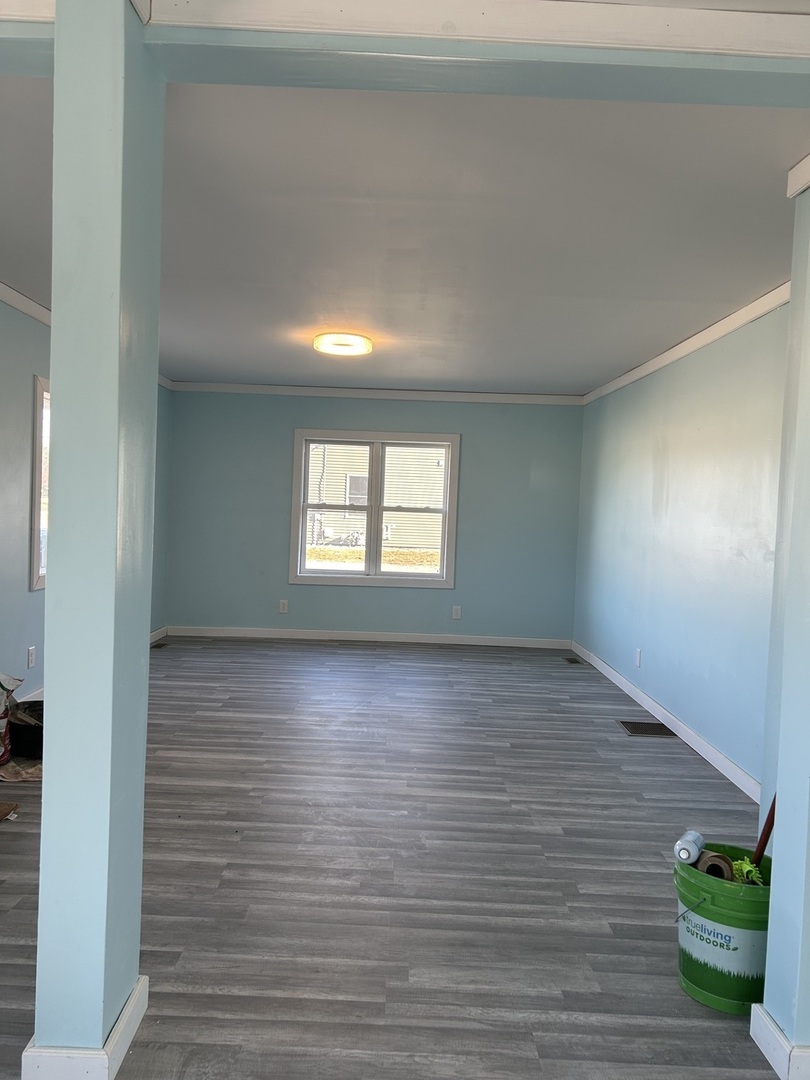 129 West Main Street Amboy, IL 61310 - Photo 18 of 40 a view of an empty room with window and wooden floor