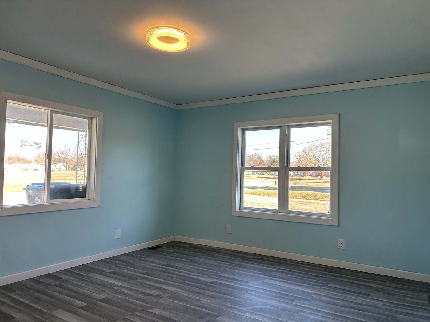 129 West Main Street Amboy, IL 61310 - Photo 19 of 40 a view of an empty room with wooden floor and a window