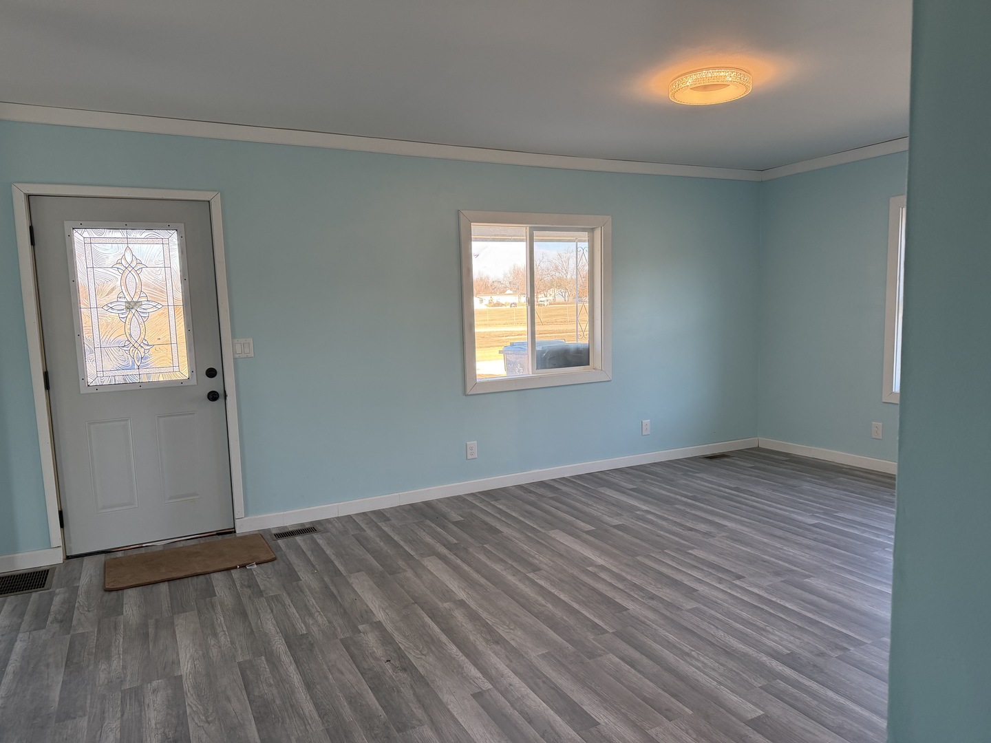 129 West Main Street Amboy, IL 61310 - Photo 21 of 40 an empty room with wooden floor and windows