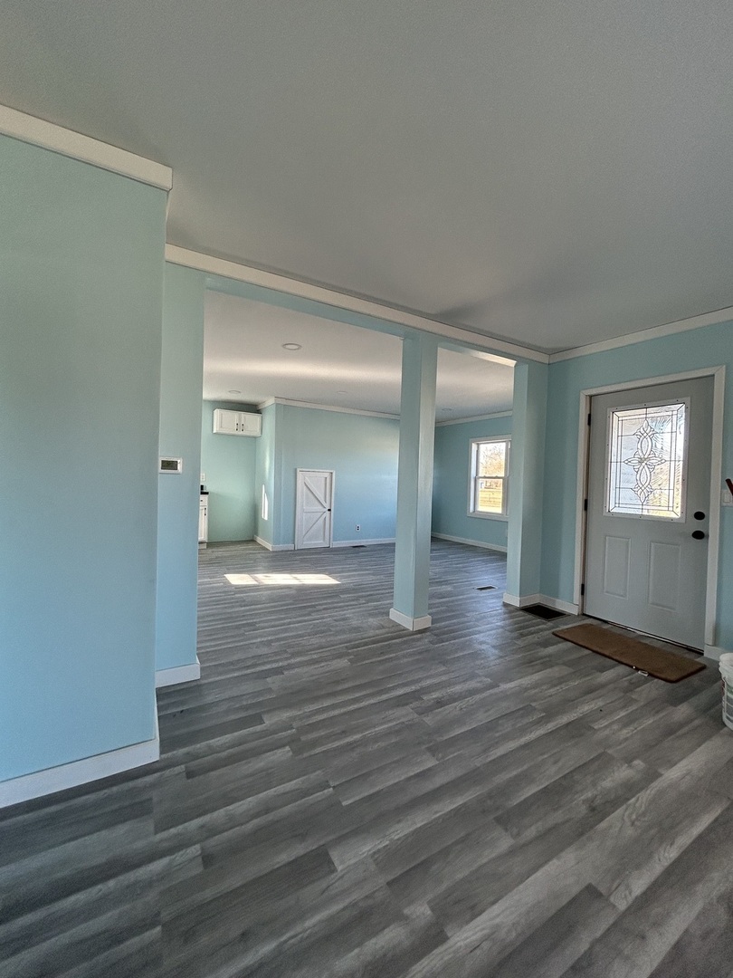 129 West Main Street Amboy, IL 61310 - Photo 25 of 40 a view of an empty room with window and wooden floor