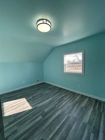 a view of a room with wooden floor and staircase