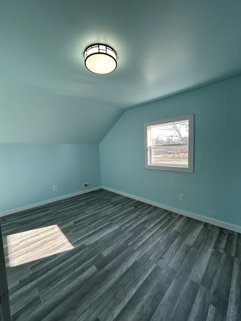 129 West Main Street Amboy, IL 61310 - Photo 29 of 40 a view of empty room with wooden floor and fan