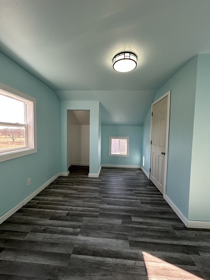 129 West Main Street Amboy, IL 61310 - Photo 30 of 40 a view of a room with wooden floor and staircase