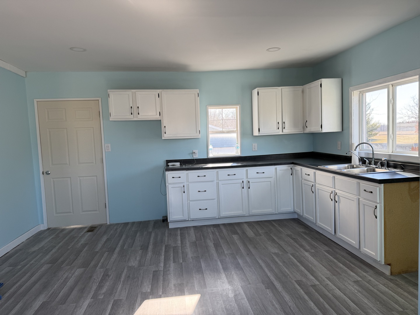 129 West Main Street Amboy, IL 61310 - Photo 34 of 40 a kitchen with granite countertop a sink cabinets and wooden floor