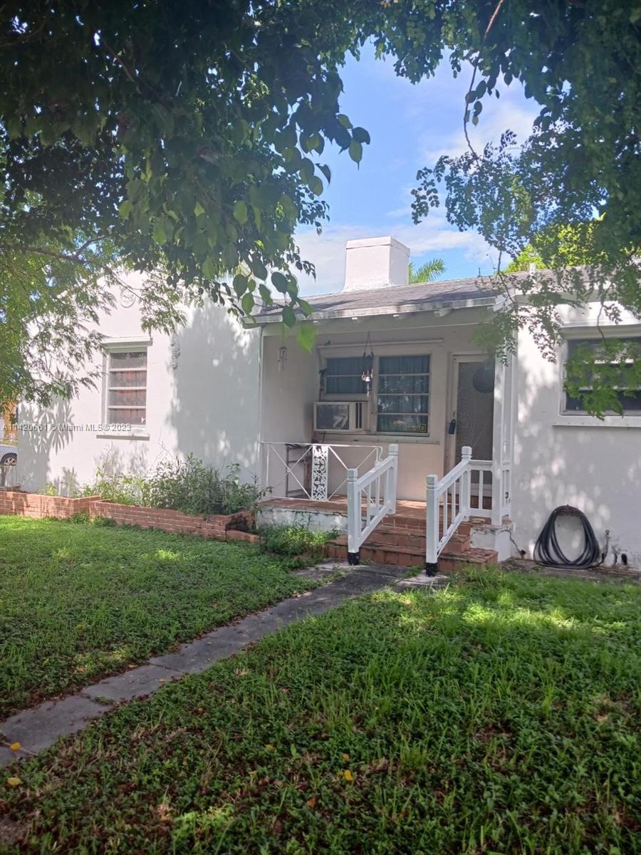 350 Southwest 34th Avenue Miami, FL 33135 - Photo 1 of 24 a front view of a house with garden and trees