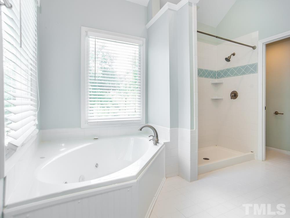 3608 Willow Bluff Drive Raleigh, NC 27604 - Photo 19 of 29 a white bath tub sitting next to a shower