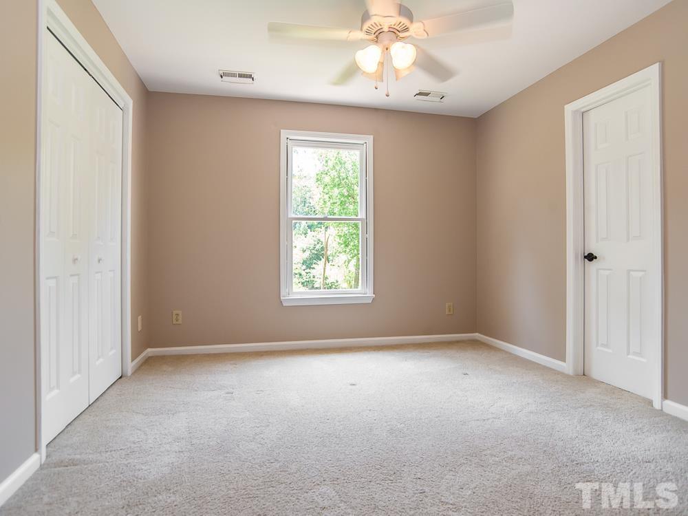 3608 Willow Bluff Drive Raleigh, NC 27604 - Photo 25 of 29 an empty room with a window and a chandelier fan