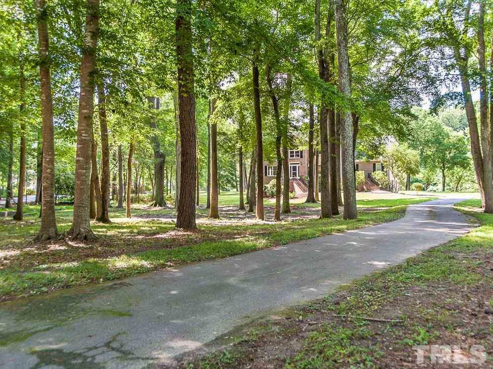 3608 Willow Bluff Drive Raleigh, NC 27604 - Photo 5 of 29 a view of a house with large trees and a yard