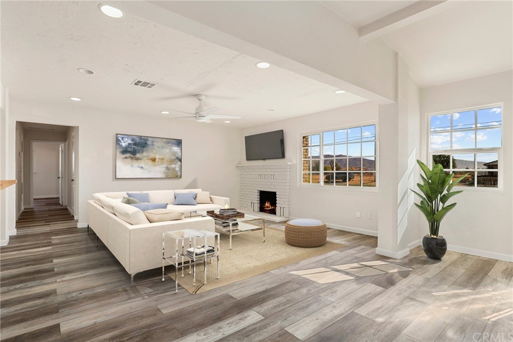 15420 Navajo Road Apple Valley, CA 92307 - Photo 1 of 1 a living room with furniture a flat screen tv and a potted plant