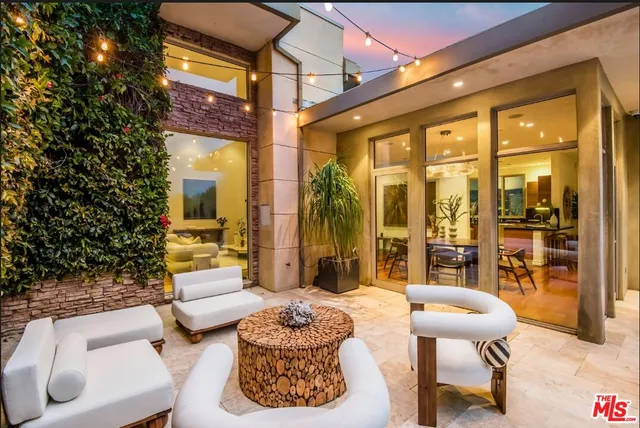 a balcony with furniture and a potted plant