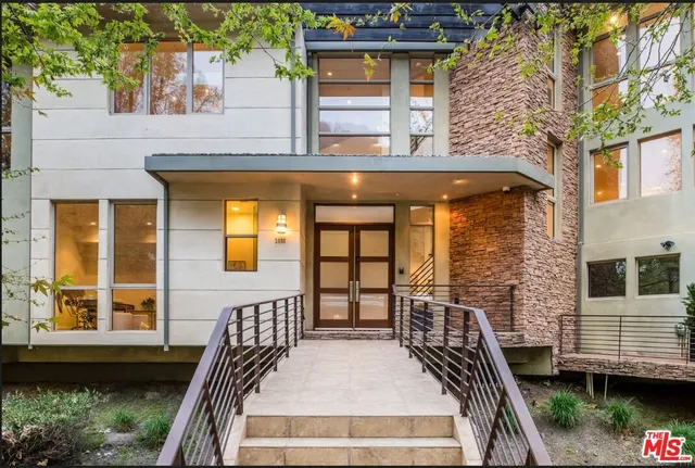 a view of a house with a wooden deck