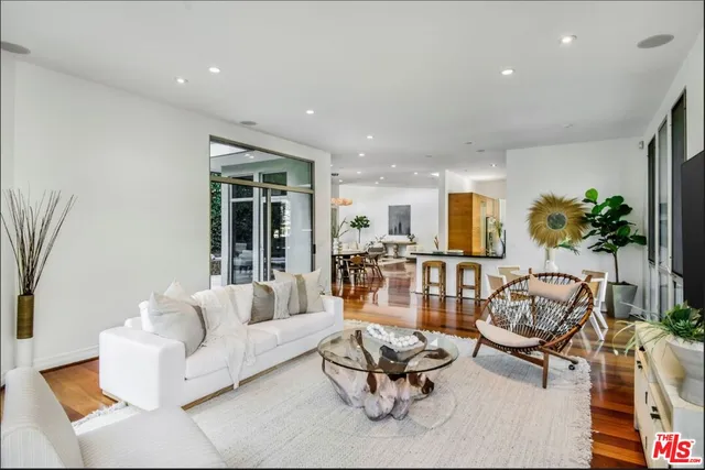 a living room with furniture and floor to ceiling windows