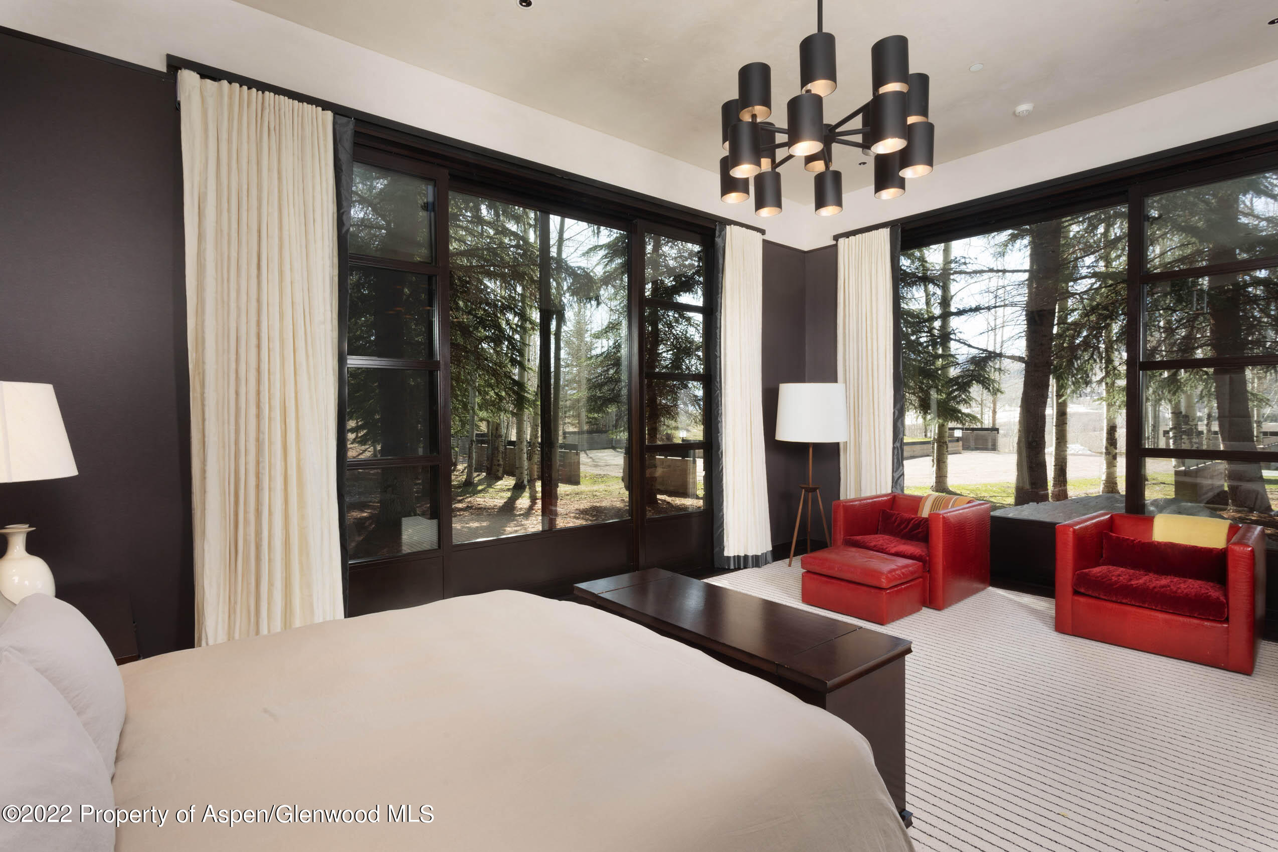 600 Owl Creek Ranch Road Aspen, CO 81611 - Photo 22 of 84 a bedroom with a large bed and a large window