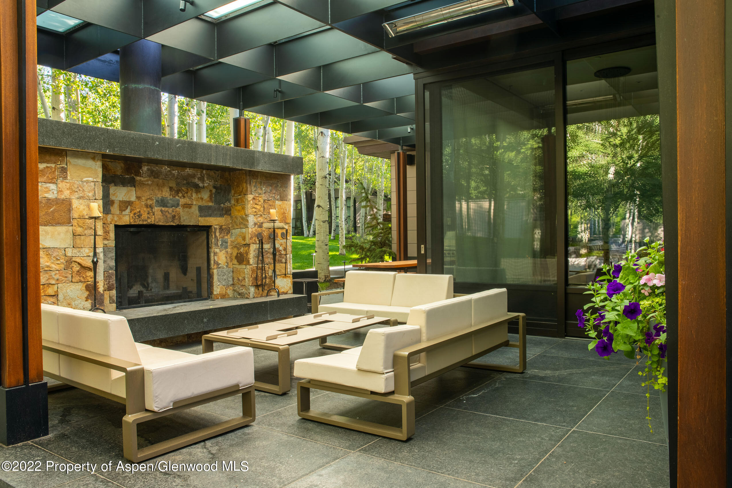600 Owl Creek Ranch Road Aspen, CO 81611 - Photo 33 of 84 a outdoor space with patio furniture and a fireplace
