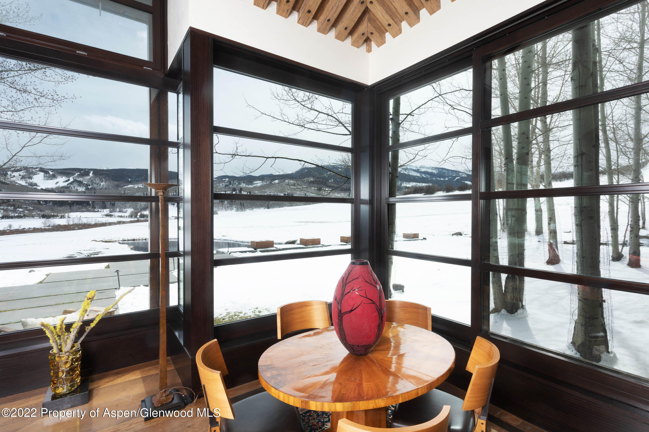 600 Owl Creek Ranch Road Aspen, CO 81611 - Photo 45 of 84 a dining room with furniture a chandelier and wooden floor