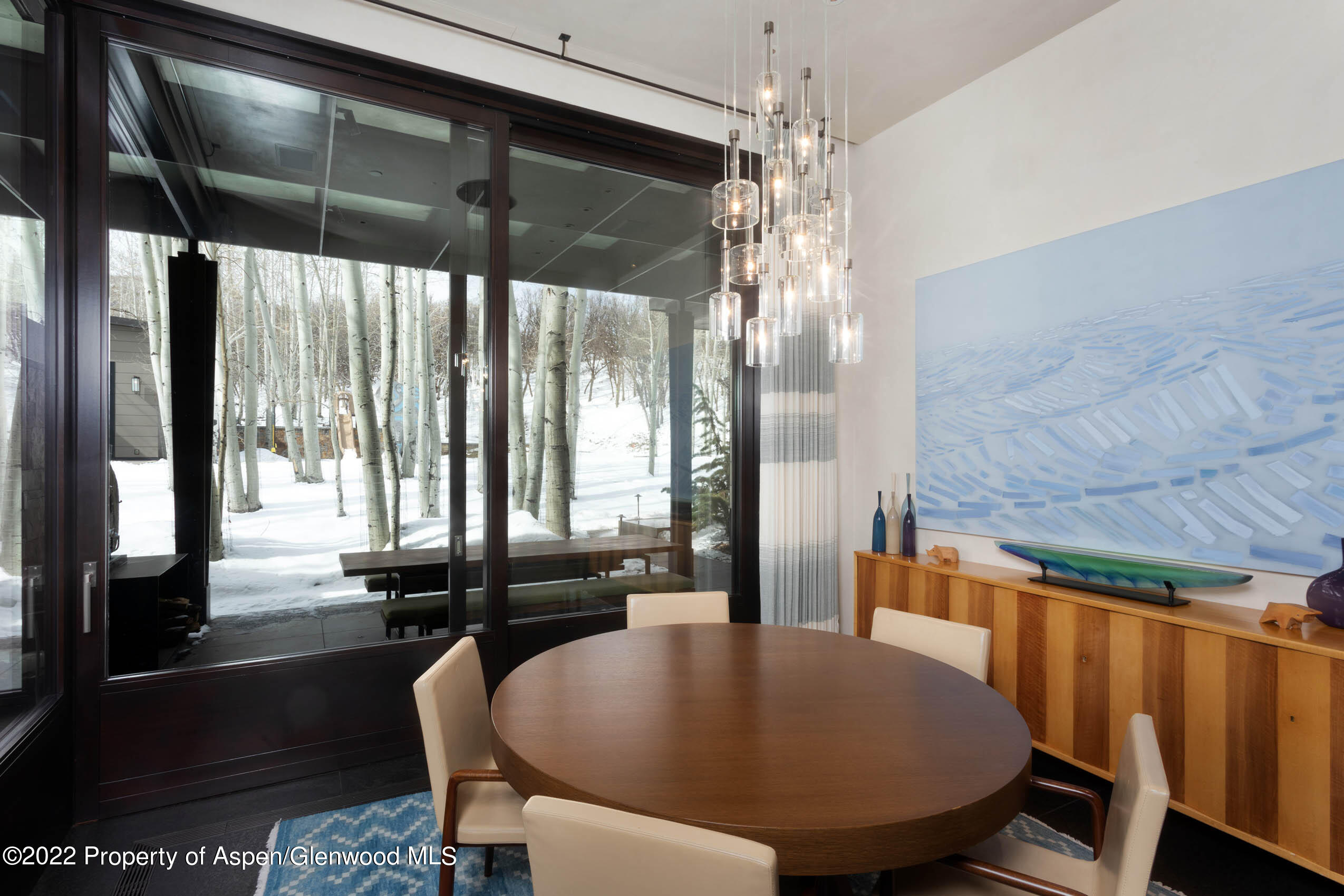 600 Owl Creek Ranch Road Aspen, CO 81611 - Photo 46 of 84 a view of a dining room with furniture window and wooden floor