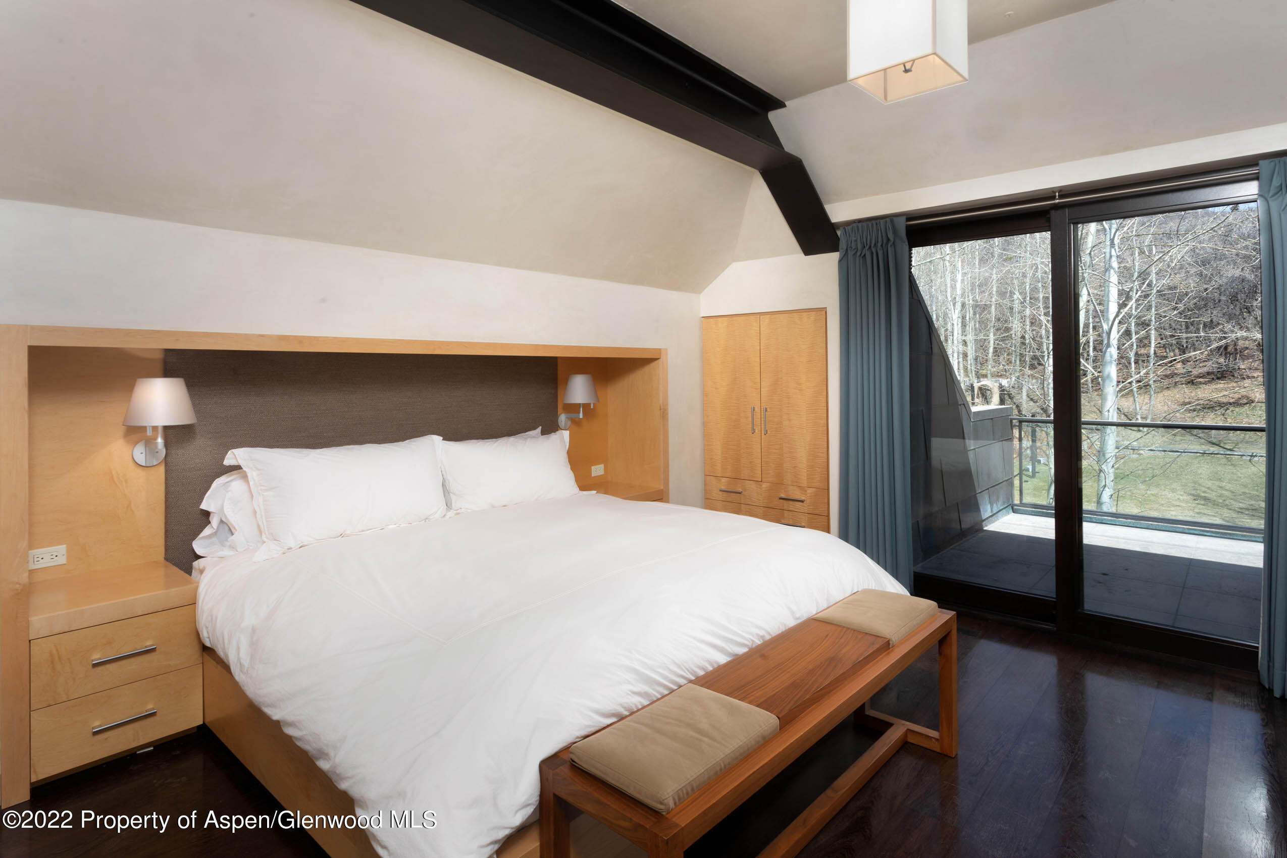 600 Owl Creek Ranch Road Aspen, CO 81611 - Photo 52 of 84 a bedroom with a large bed and a large window