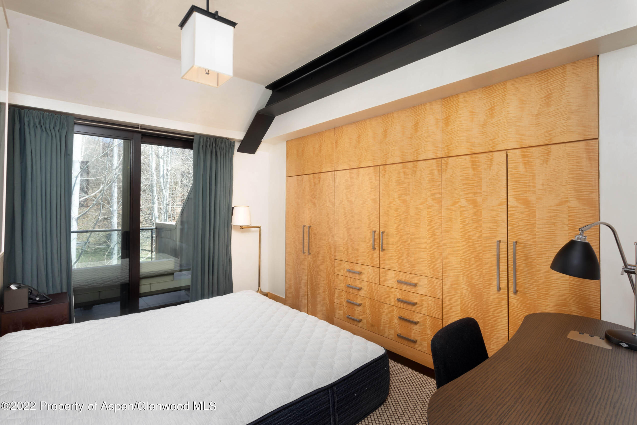 600 Owl Creek Ranch Road Aspen, CO 81611 - Photo 53 of 84 a bedroom with a bed and a large window