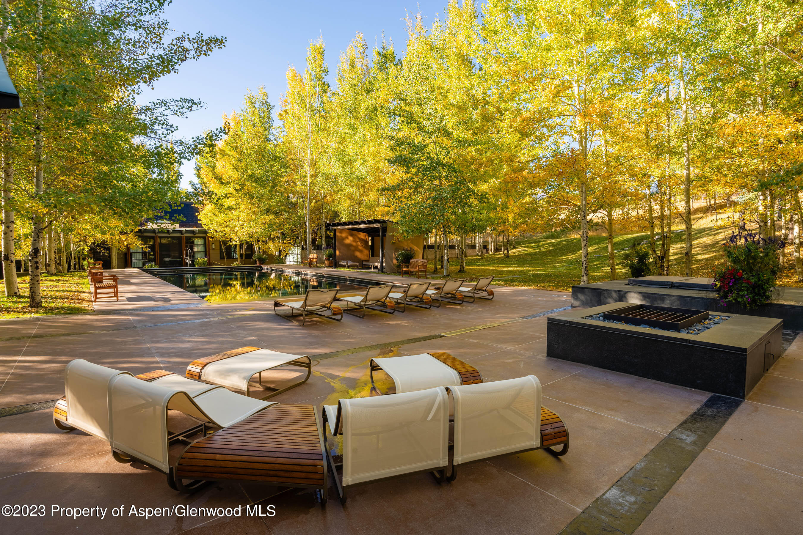 600 Owl Creek Ranch Road Aspen, CO 81611 - Photo 77 of 84 a view of a swimming pool with couches and lounge chairs