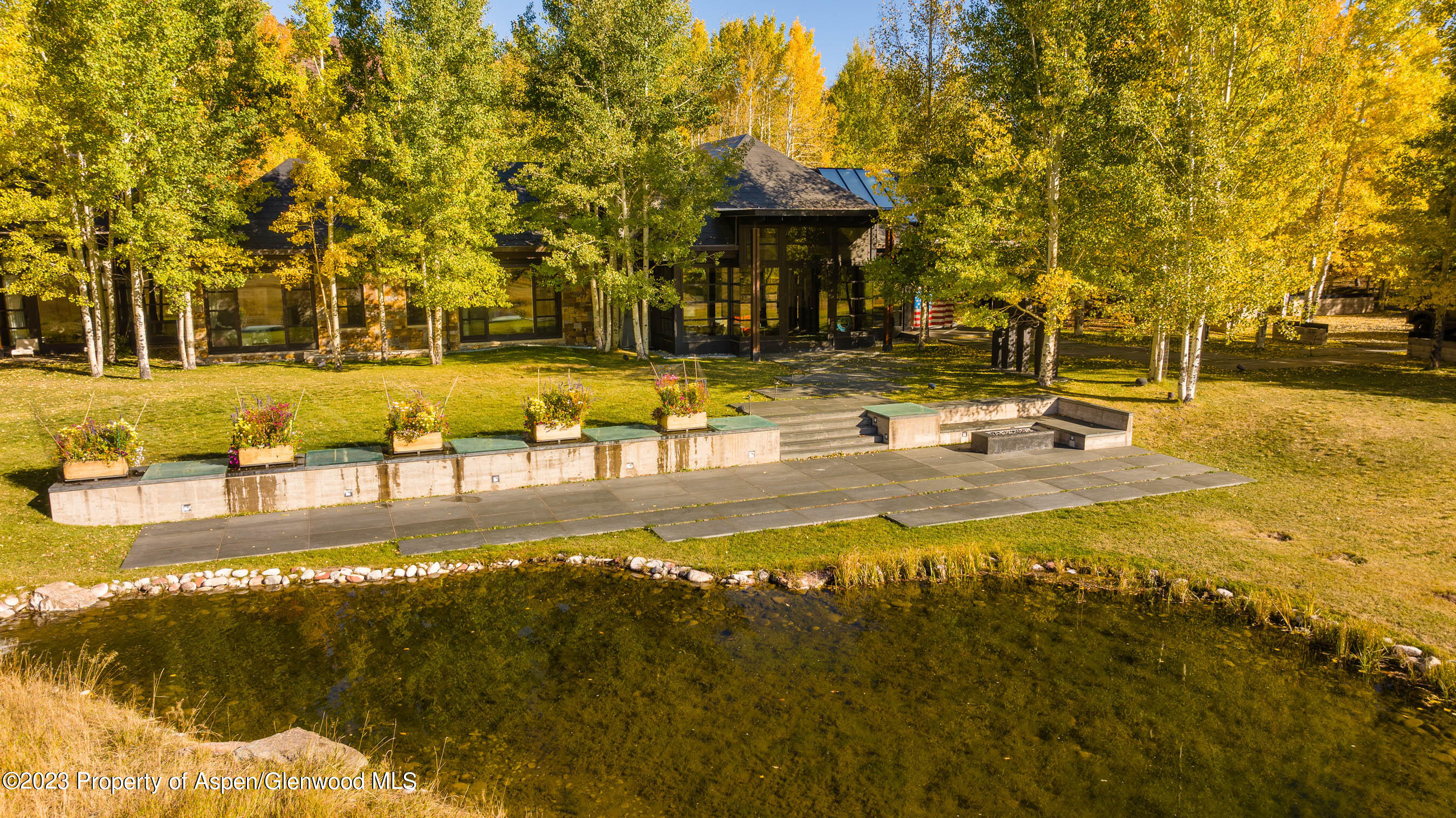 600 Owl Creek Ranch Road Aspen, CO 81611 - Photo 80 of 84 a view of a swimming pool with an outdoor space and seating area